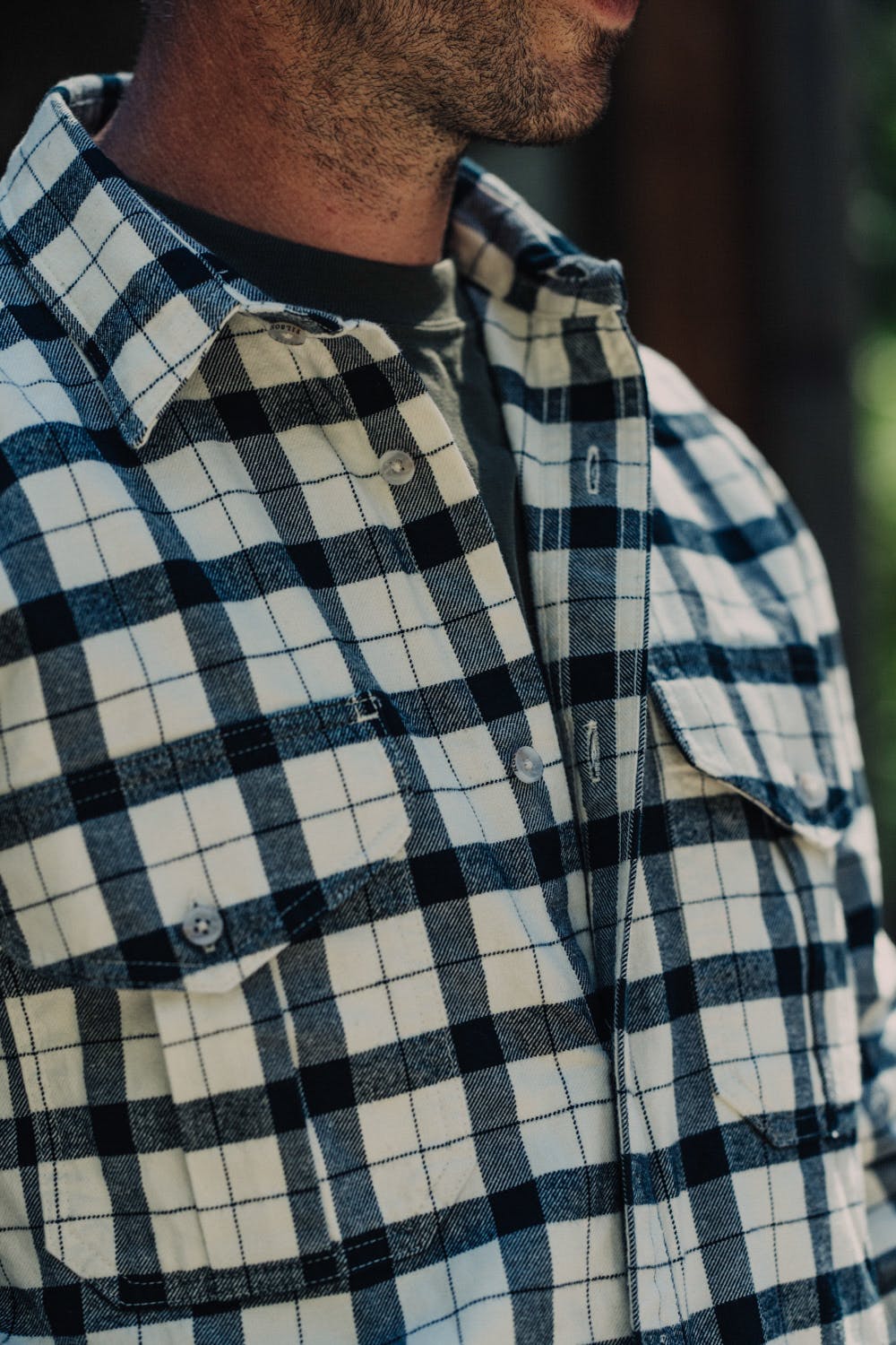 Man wearing an unbuttoned Filson Alaskan Guide Shirt