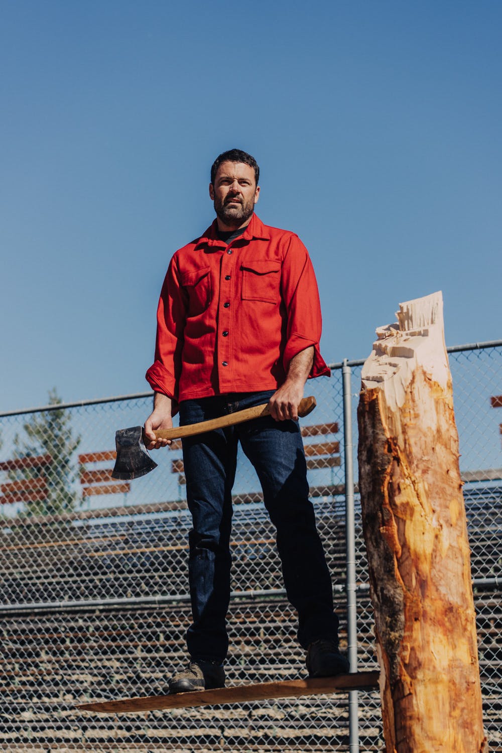Man wearing Filson Jac-Shirt in scarlet red holding an axe