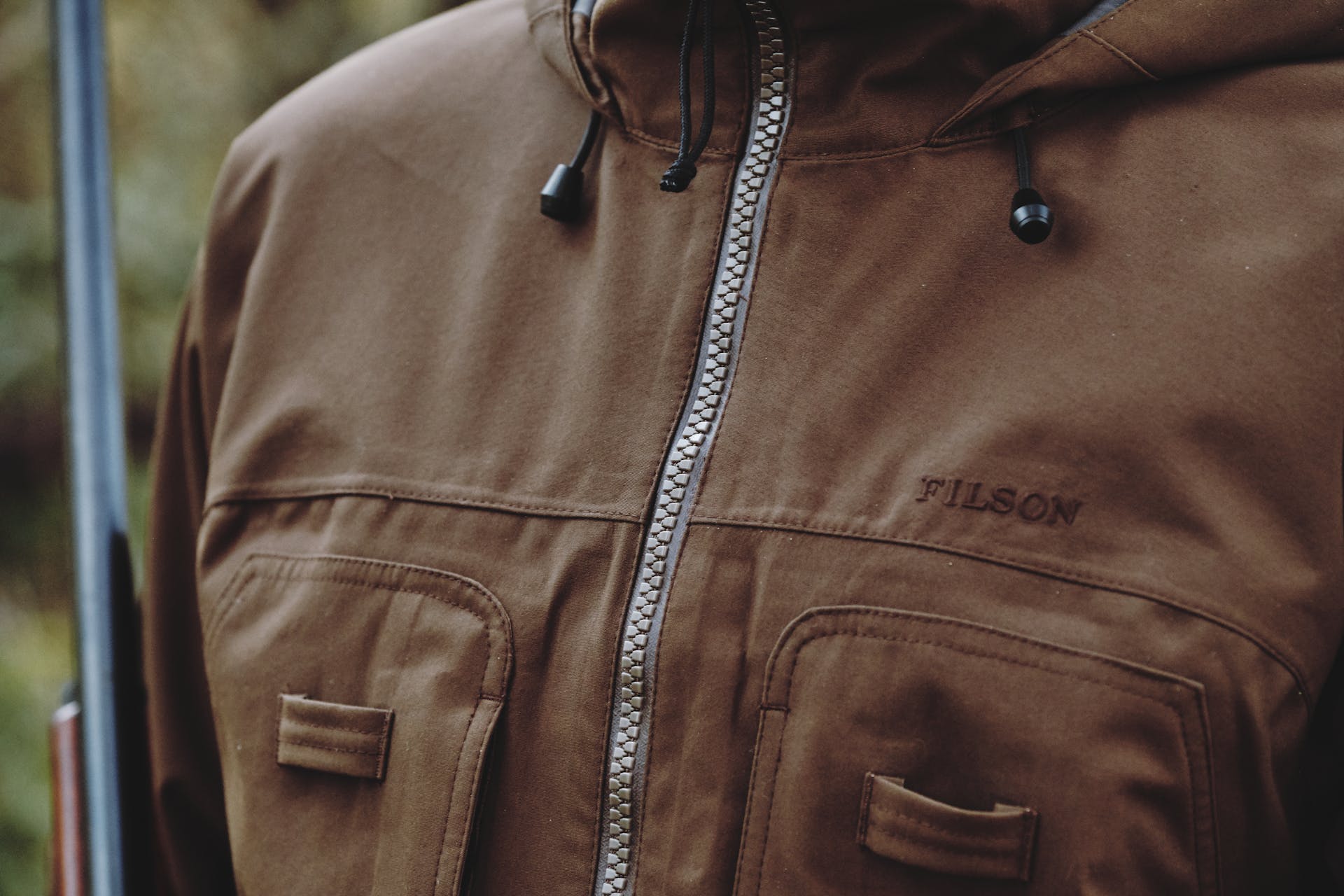 Close-up view of a Filson 3-Layer Field Jacket worn by a hunter in the field