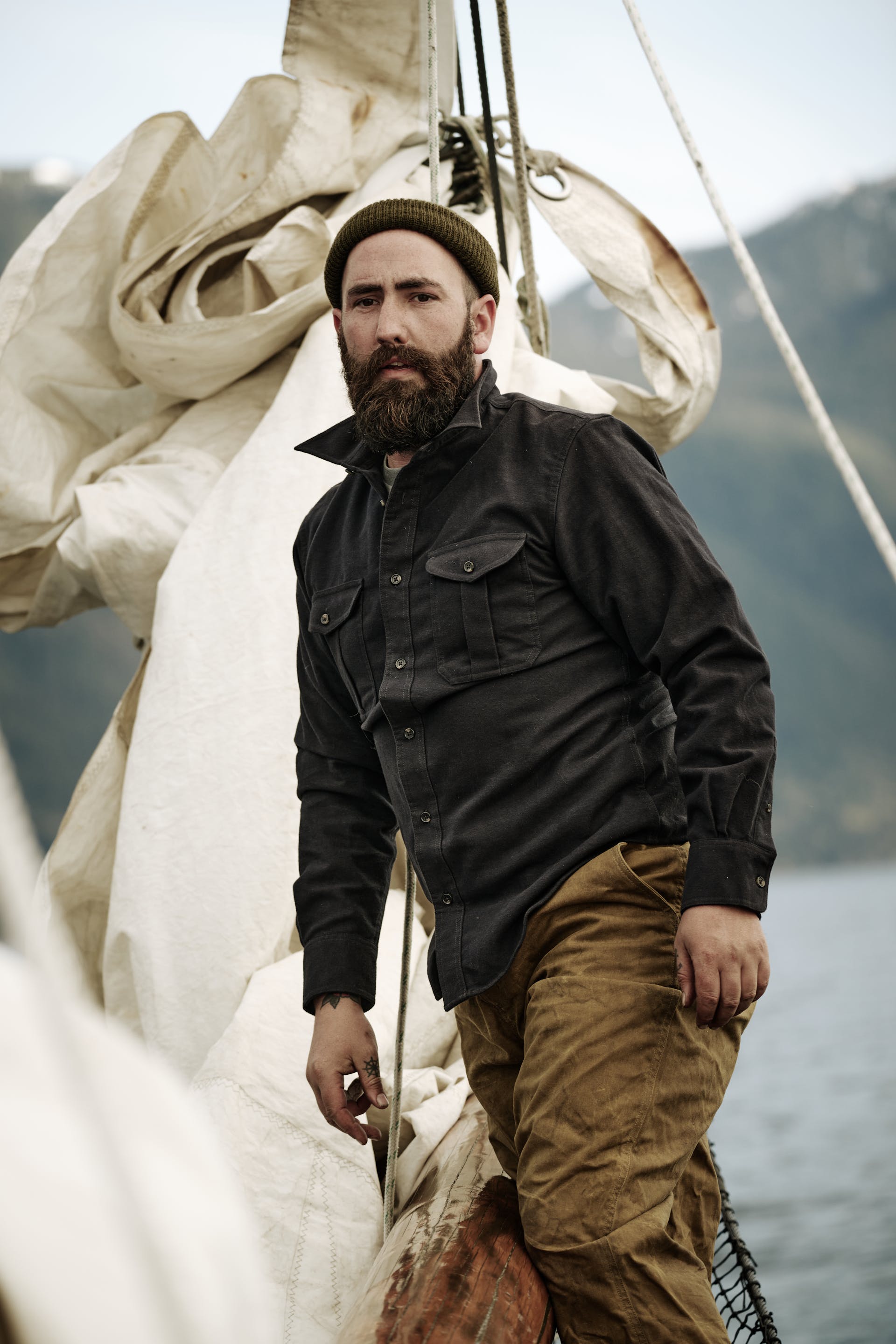 A sailor standing on a boat wearing a Filson Moleskin Seattle Shirt