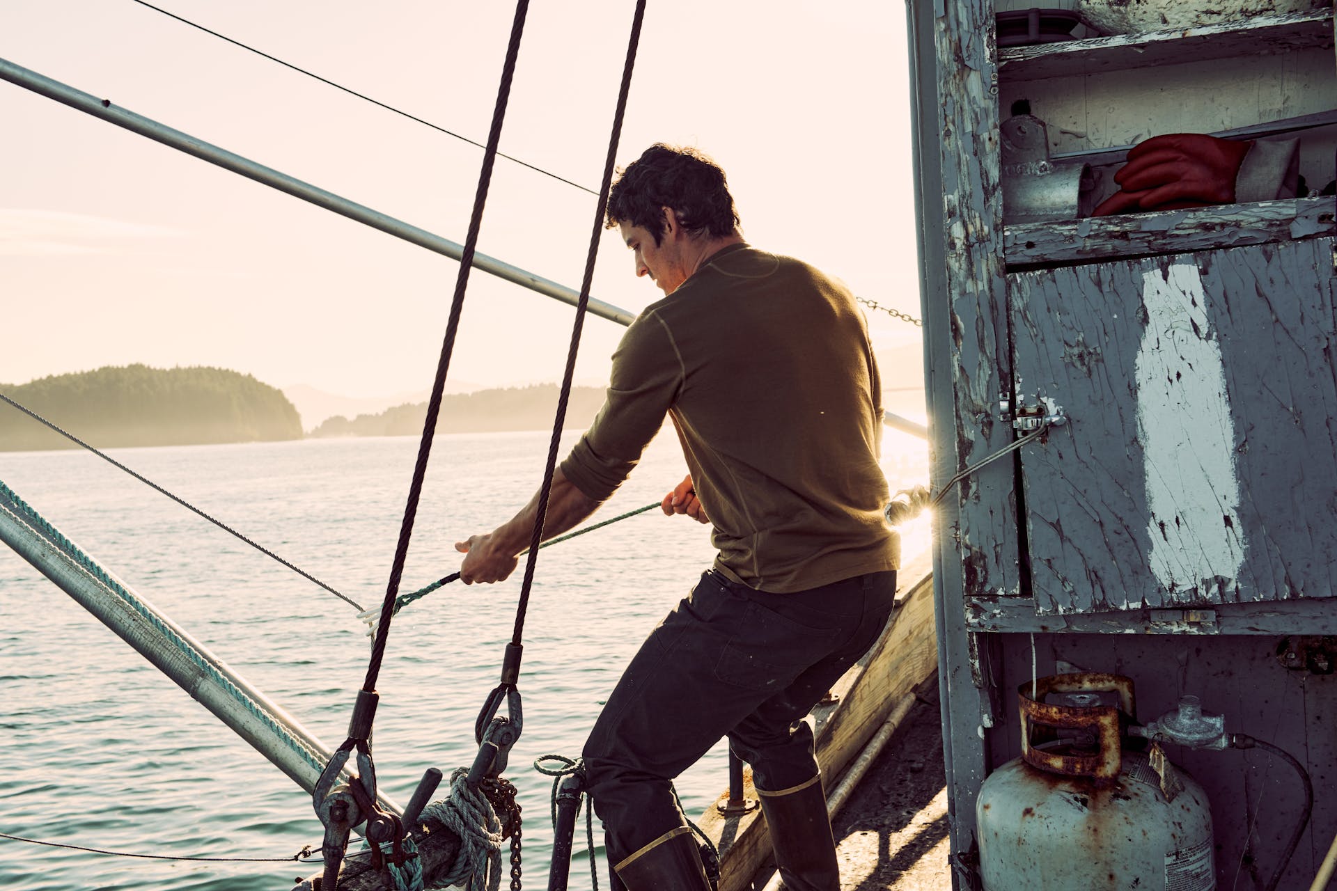 Fisherman pulling on a rope wearing a Filson 280G Merino Long Sleeve Crew shirt